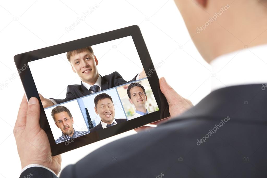 businessman attending video conference with colleague on digital tablet