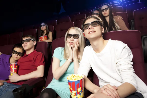 Young people sitting at the cinema, watching a film Stock Photo