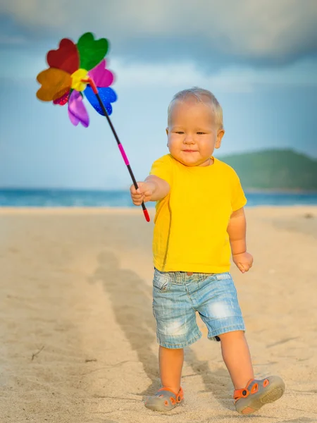 Baby with toy windmill — Stock Photo, Image