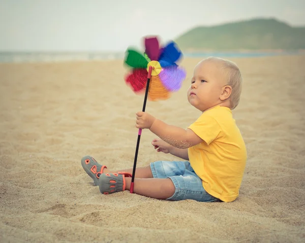 Baby with toy windmill — Stock Photo, Image