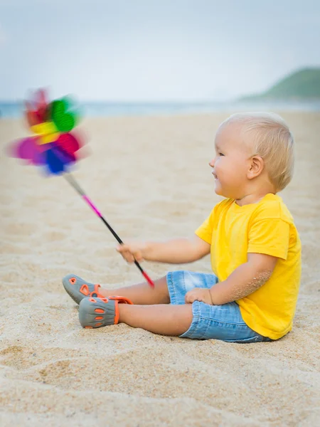 Baby with toy windmill — Stock Photo, Image