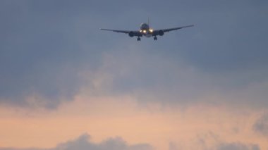 Plane flies at dusk for landing