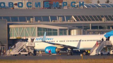 Airport passengers boarding on a plane