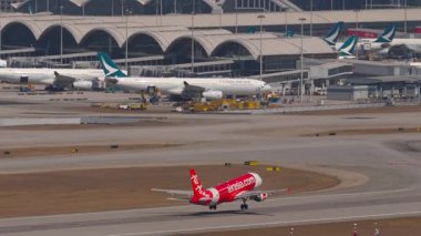 HONG KONG - 28 HAZİRAN 2025 Airbus A320 AirAsia yolcuları düşük maliyetli kalkış Chek Kap Kok havaalanı, Hong Kong, yan görüş
