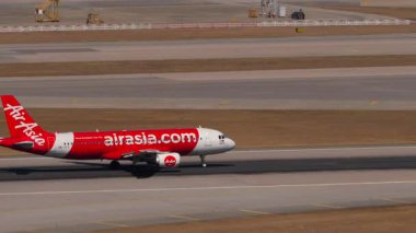 HONG KONG - 28 HAZİRAN 2025 Airbus A320 AirAsia yolcuları düşük maliyetli kalkış Chek Kap Kok havaalanı, Hong Kong, yan görüş