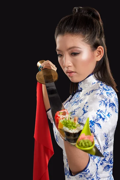 Woman holding sushi on katana — Stock Photo, Image