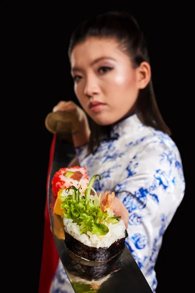 Woman holding sushi on katana — Stock Photo, Image