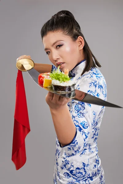 Mujer sosteniendo sushi en katana —  Fotos de Stock