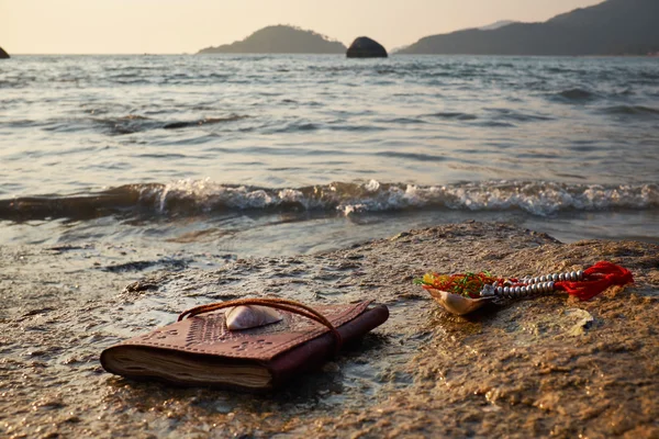Rocky beach with old notebook — Stock Photo, Image