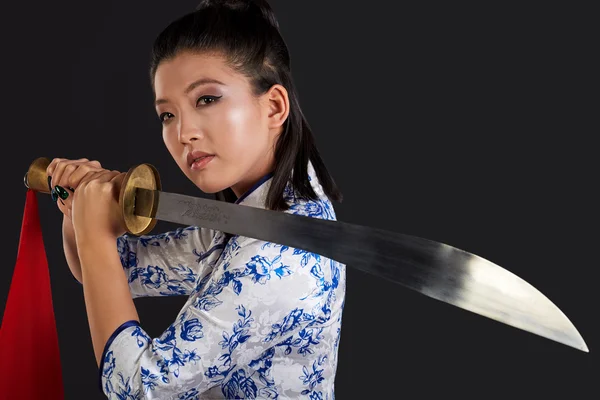 Beautiful woman holding sword — Stock Photo, Image