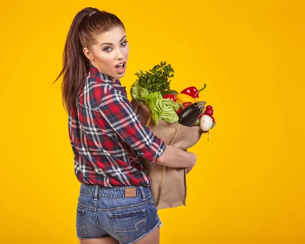 Kvinna med matkassen och grönsaker — Stockfoto