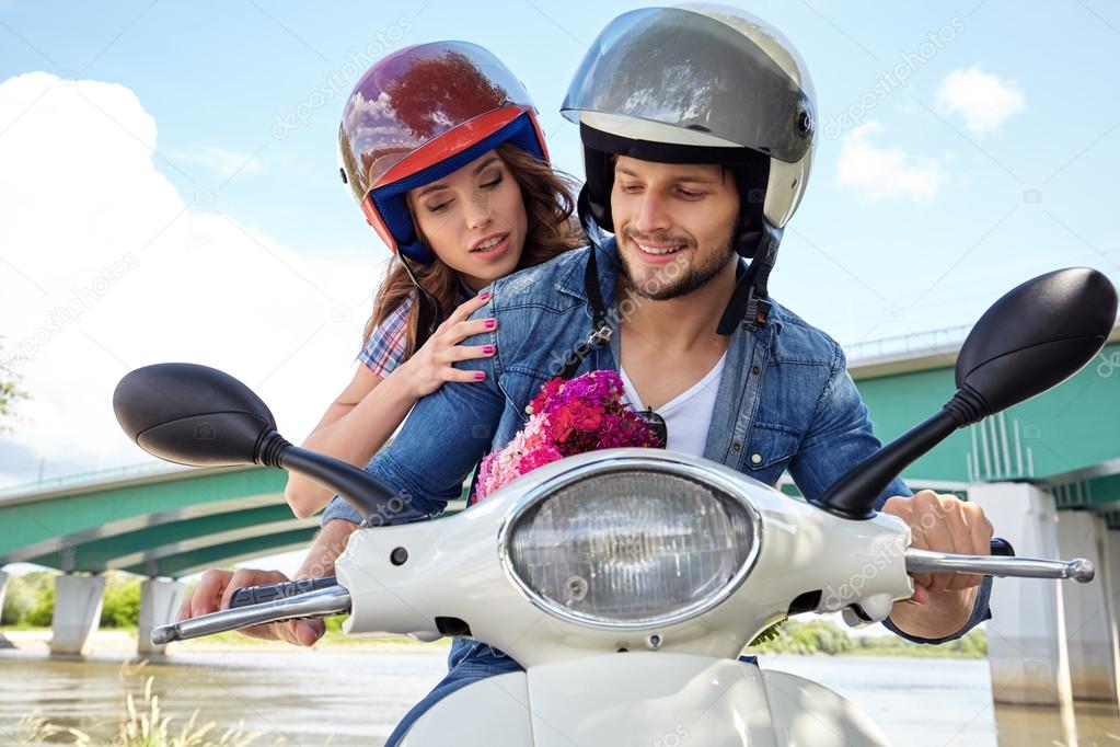 couple on scooter driving together