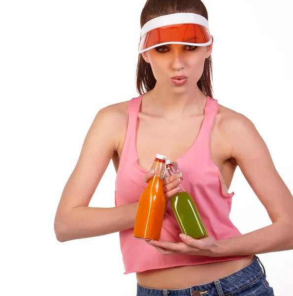 Woman in pink top holding bottles — Stock Photo, Image