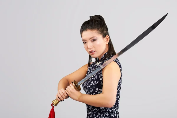 Beautiful woman holding sword — Stock Photo, Image