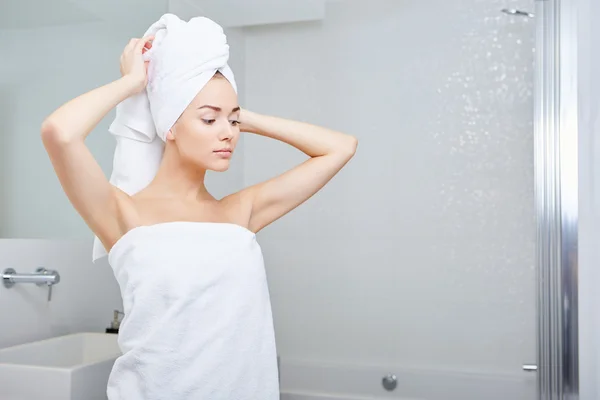 Woman wrapped in white towels — Stock Photo, Image