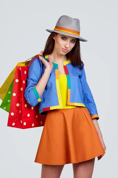 Woman in hat with bags — Stock Photo, Image