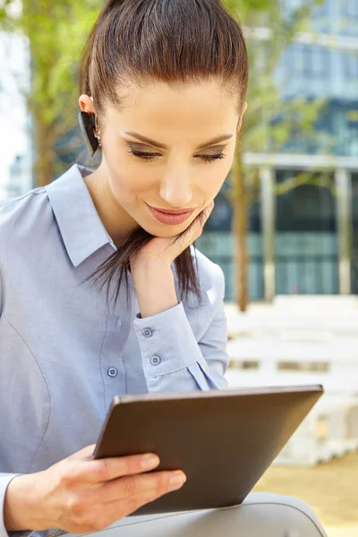 Businesswoman working with Bluetooth headset — Stock Photo, Image