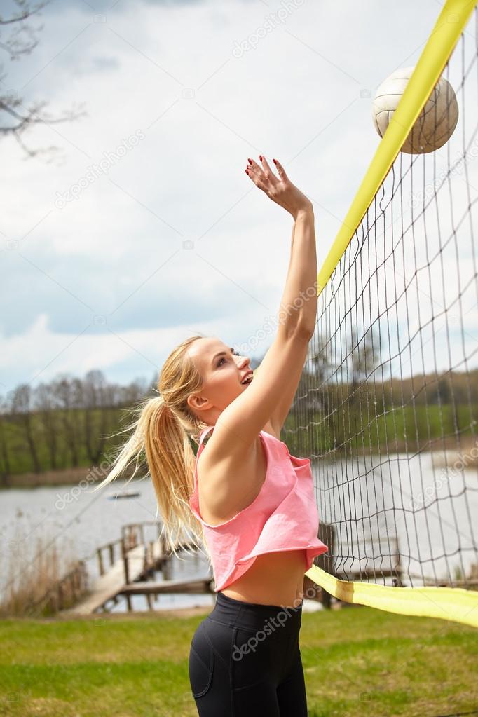 Sexy blond girl playing volleyball Stock Photo by ©zoomteam 113219644