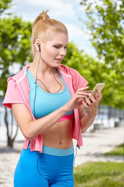 Vrouw op pier bedrijf telefoon — Stockfoto