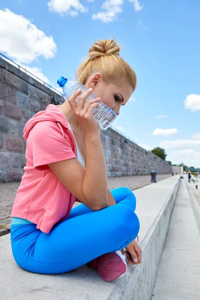 Woman with water after outdoor workout — Stock Photo, Image