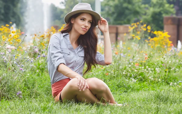 Spring woman sits on grass — Stock Photo, Image