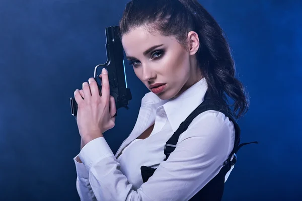 Beautiful girl holding gun — Stock Photo, Image