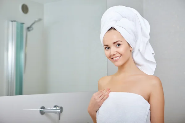 Woman wrapped in white towels — Stock Photo, Image