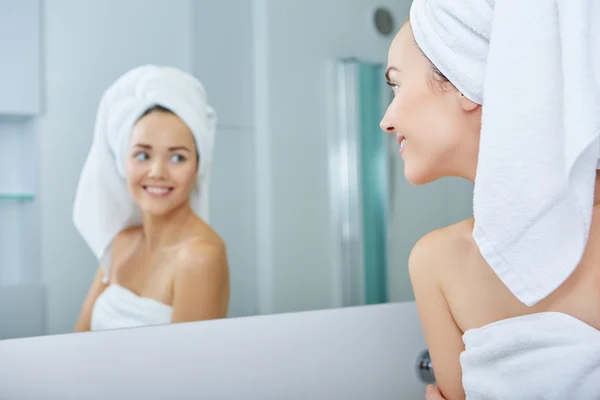 Woman wrapped in white towels — Stock Photo, Image