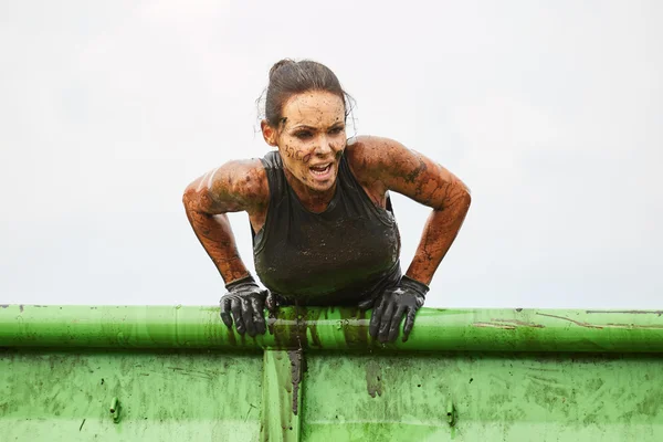 woman climbs in top on barrier