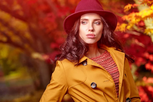 Frau steht im Herbst im Park — Stockfoto