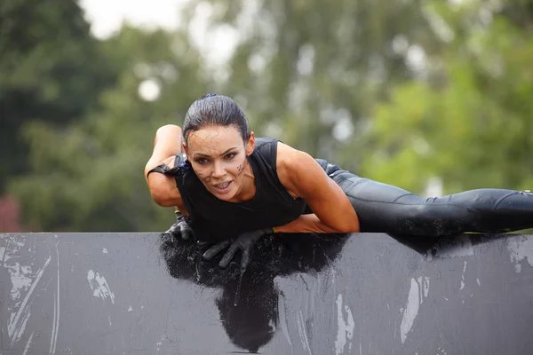 woman in dirt on an obstacle course