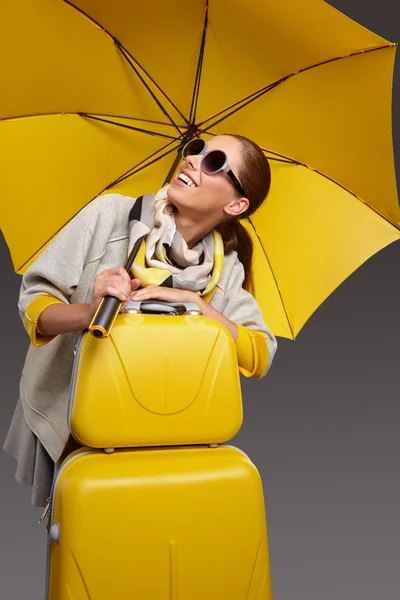 Woman with umbrella and suitcase — Stock Photo, Image