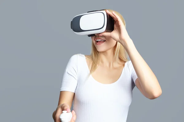 young woman looking through some VR glasses