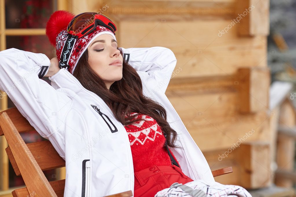 Woman skier in wooden  home terrace 