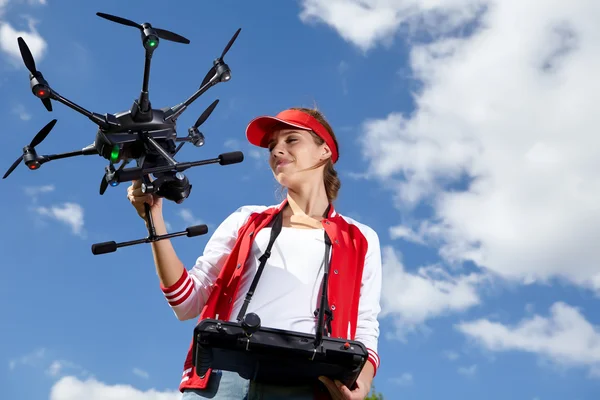 Woman with remote control and flying surveillance drone — Stock Photo, Image