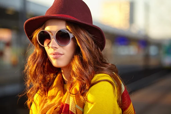 Mooie jonge vrouw op een treinstation — Stockfoto