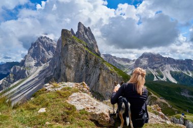 Dolomitlerdeki yürüyüşçüler gölün etrafındaki ormanda dağ yürüyüşü patikalarında yürürler.