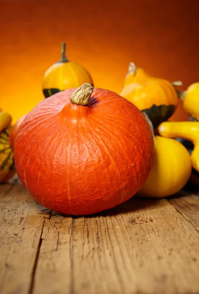 Decorative pumpkins on old wooden table — Stock Photo, Image