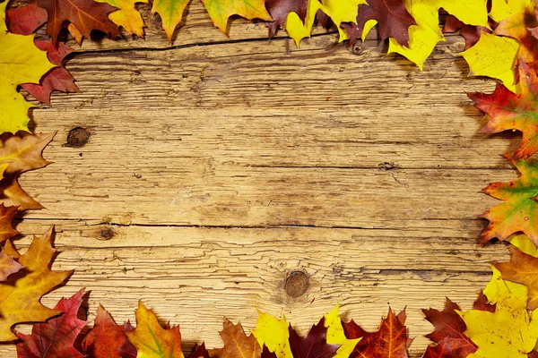 Hojas de otoño sobre mesa de madera — Foto de Stock