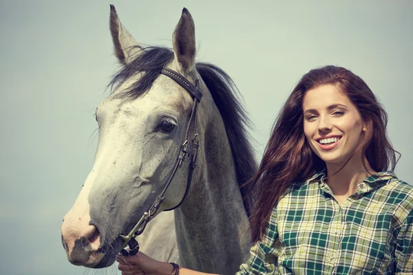 Woman with a white horse — Stock Photo, Image