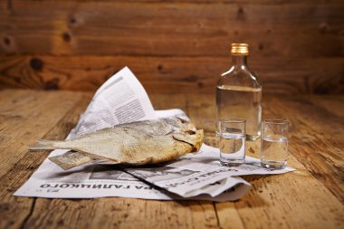 Dried fish on old newspaper clipart