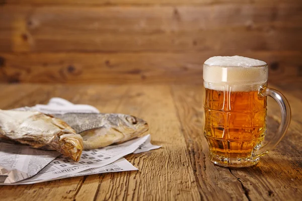 Beer and dried fish on wooden table — Stock Photo, Image