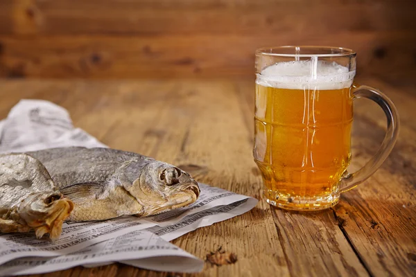 Beer and dried fish on wooden table — Stock Photo, Image