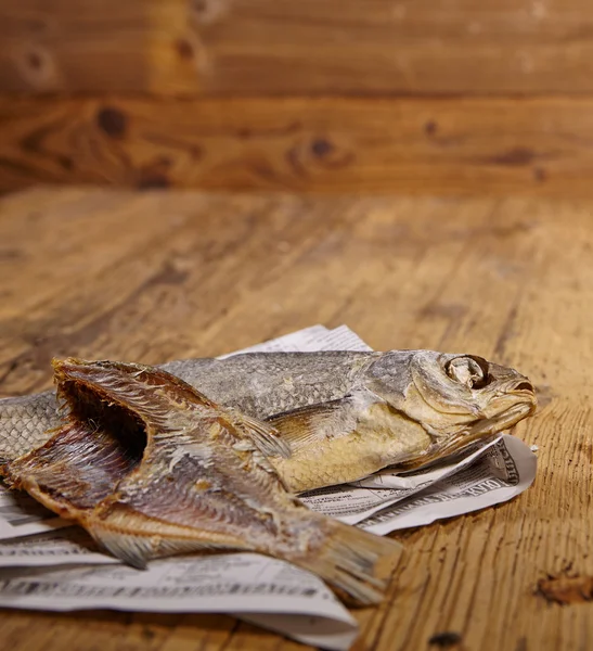 Dried fish on old newspaper — Stock Photo, Image