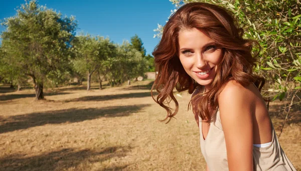 Woman under an olive tree — Stock Photo, Image