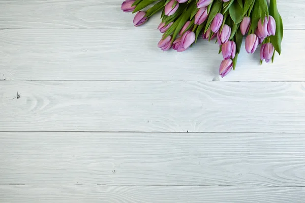 Purple tulips  on old used wood — Stock Photo, Image