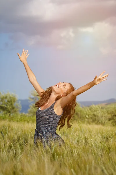 Vrouw in tarwe veld genieten van — Stockfoto