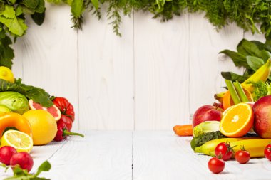 Fruits and vegetables on wooden table clipart