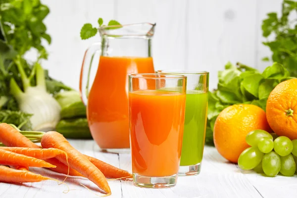 Carrot juice on white wood table — Stock Photo, Image