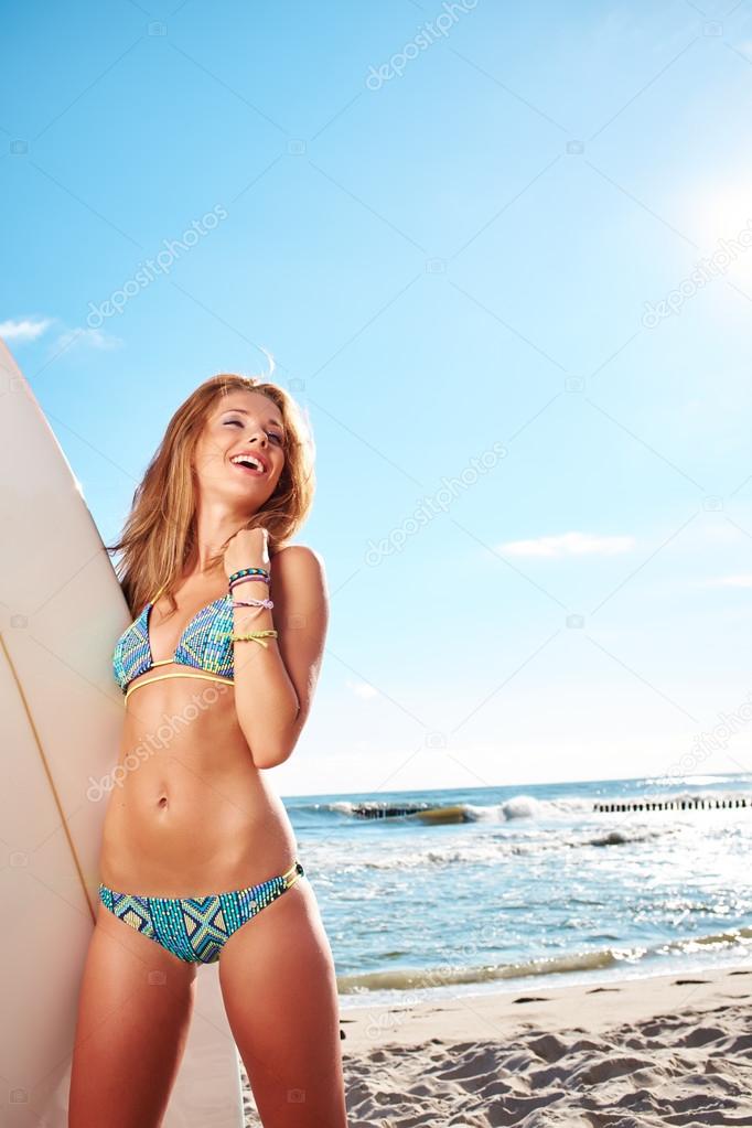 Beautiful sexy surfer girl on the beach